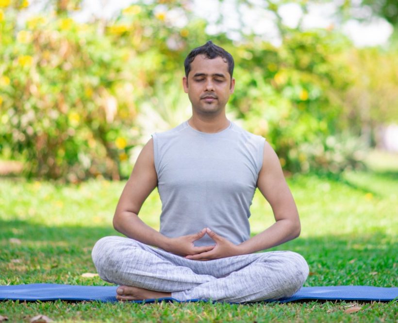 focused-young-indian-man-meditating-lotus-pose