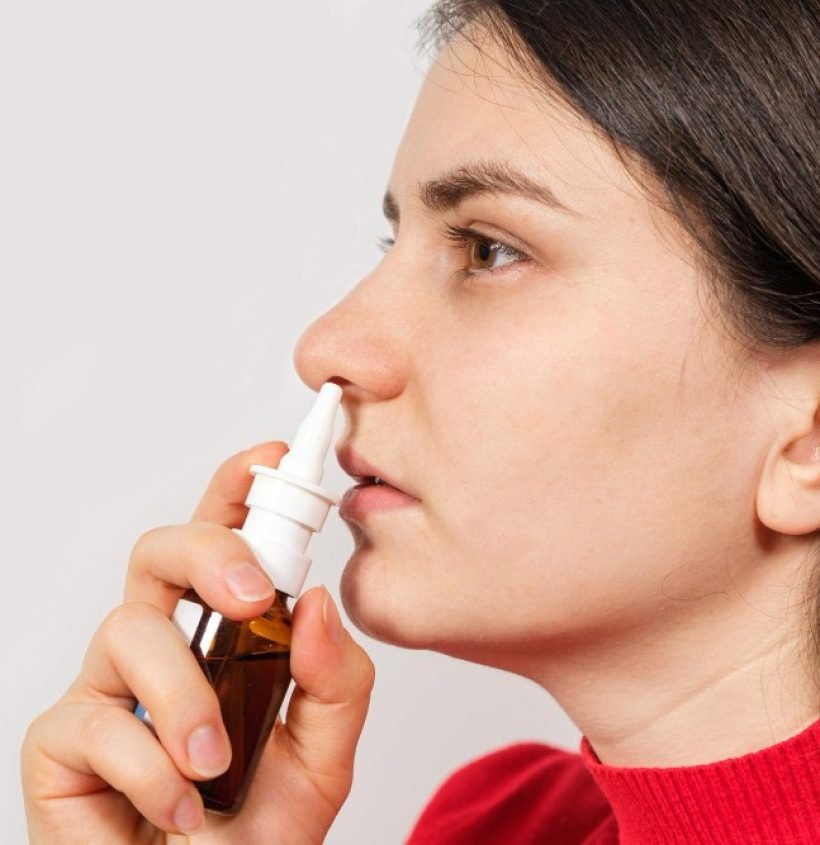 female-patient-shoves-spray-into-nose-treat-rhinitis-allergy-with-difficulty-breathing-copy-text-space