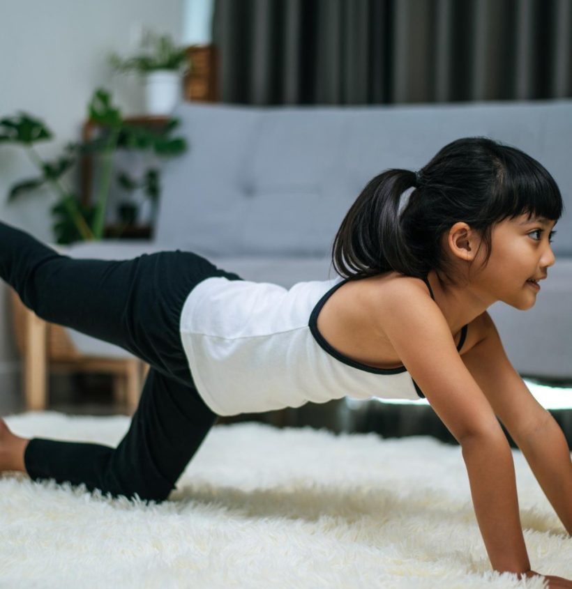 girl-doing-yoga-room-white-carpet-selective-focus